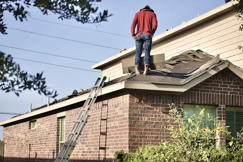 Professional roofer working on a residential roof in Port Richey